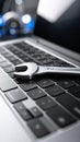 Metal wrench resting on a modern laptop keyboard for technical support and computer repair Royalty Free Stock Photo
