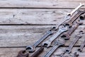 Metal wrench rusty tools lying on a black wooden table. Hammer, chisel, hacksaw, metal wrench.Copy space Royalty Free Stock Photo