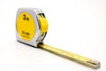 Metal yellow tape measure on white background flexible ruler used to measure distance.