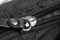 Metal zipper on black synthetic fabric