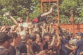 Metalhead in wheelchair during a crowdsurfing at a metal concert