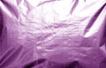 Metalized plasrtic wrap texture with crumples in purple tone Royalty Free Stock Photo