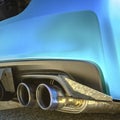 Metallic blue car with dual exhaust pipe