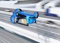 Metallic blue VTOL drone with delivery packages flying beside highway bridge