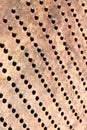 Metallic bronze textured background with pattern of round cells in diagonal, vertical Royalty Free Stock Photo