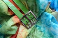 Metallic buckle and green belt on rayon