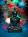 Metallic buddha statuette on colorful background Royalty Free Stock Photo