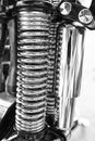 Metallic chrome hydraulic damper absorber or rear suspension shock motorcycle custombike part Royalty Free Stock Photo