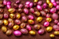 Metallic colored easter eggs with some detail on wooden table Royalty Free Stock Photo