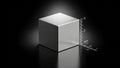A metallic cube with a brushed finish sits on a reflective black surface Royalty Free Stock Photo
