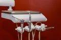 Metallic dentist tools close up on a dentist chair in Dentist Clinic red tone Royalty Free Stock Photo