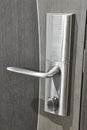 Steel door knob with lock on a grey wooden door Royalty Free Stock Photo