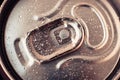 Metallic drink can with water drops. Shiny beer can close-up. Golden bottle of drink, lid of packaging of cola. Top view Royalty Free Stock Photo