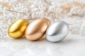 Metallic easter eggs in gold, silver, and bronze on marble surface for elegant holiday decor Royalty Free Stock Photo