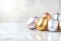 Metallic easter eggs in gold, silver, and bronze on marble surface for elegant holiday decor Royalty Free Stock Photo