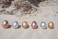 Metallic Easter Eggs in the sand Royalty Free Stock Photo