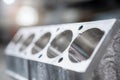 Metallic engine block with polished cylinder bores ready for assembly highlighting precision machining in an industrial workshop Royalty Free Stock Photo