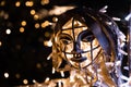 Metallic face of an angel with Christmas lights inside and behind