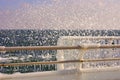 Metallic fence in the ice with wave foam splash