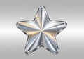 A metallic five-pointed star with a shiny, silver finish, featuring a gradient of reflections Royalty Free Stock Photo