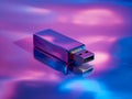 Metallic flash drive with reflective surface immersed in vibrant purple and blue lighting symbolizing modern data storage and Royalty Free Stock Photo