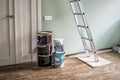Metallic folding ladder and painting tools in corridor, Home renovation Royalty Free Stock Photo