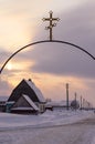 Metallic gate with Christian cross, sunset sky, small village house Royalty Free Stock Photo