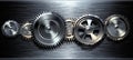 Metallic Gears on a Brushed Metal Background Industrial Teamwork and Precision Concept