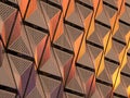 Metallic geometric cladding or panels in copper and gold colors