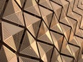 Metallic geometric cladding or panels in copper and gold colors