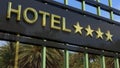 Metallic glass hotel sign board with four golden stars