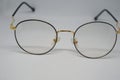 Metallic glasses with black frames on a white background. Royalty Free Stock Photo