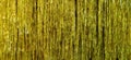 Metallic gold foil tinsel fringe decoration curtain. Birthday, wedding, Christmas, New Year party decoration background Royalty Free Stock Photo