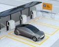 Metallic gray autonomous car recharging in parking lot Royalty Free Stock Photo