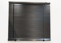 Metallic greyish black blind closed in front of the window for modern background line Royalty Free Stock Photo