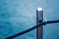 Metallic harbor pier post with rope