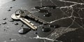 Metallic keys resting on a glossy black marble surface with droplets of water at a close angle