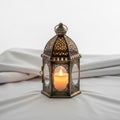Metallic lantern with intricate geometric patterns resting on a soft Royalty Free Stock Photo