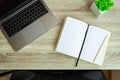 Metallic laptop and office supplies on wooden table. Top view. Office workplace minimal concept