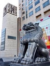 Metallic lion in front of the modern building