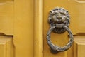 Metallic lion head knocker on a wooden door in Ouro Preto, Brazil