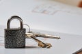 Metallic lock, keys and layout draft on apartment sale deal Royalty Free Stock Photo