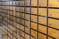 Metallic mailbox rows at postal room inside condominium building