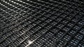 Metallic mesh in black with fine grid and diagonal light reflections on surface Royalty Free Stock Photo