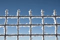 Metallic net covered with hoarfrost. Extreme cold weather concept