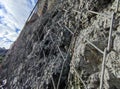 Metallic net holding for hanging rocks falling protection