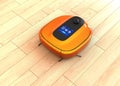 Metallic orange robotic vacuum cleaner moving on flooring