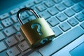 Metallic padlock with question mark sits on keyboard, shiny padlock contrasts keyboard Royalty Free Stock Photo