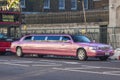 A metallic pink limousine in London