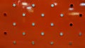 Metallic plate texture painted in red with holes Royalty Free Stock Photo